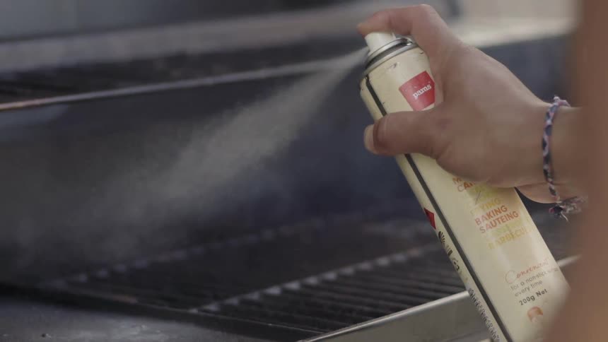 Someone Grilling Steaks Outdoors Over Open Flame During Relaxed Cooking Scene.