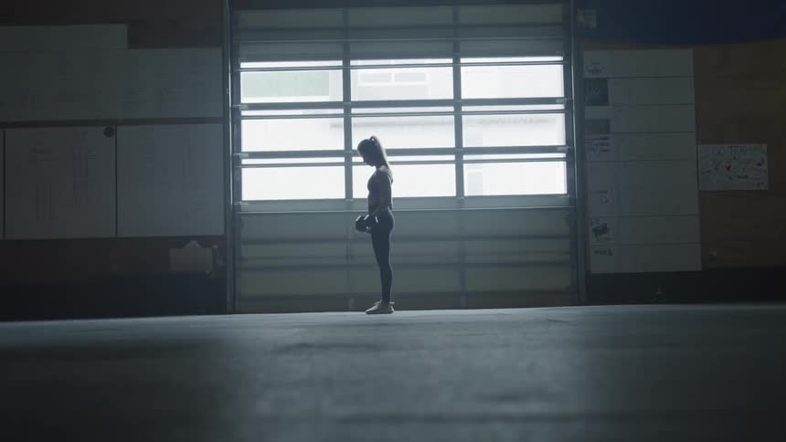 A woman is lifting weight indoors