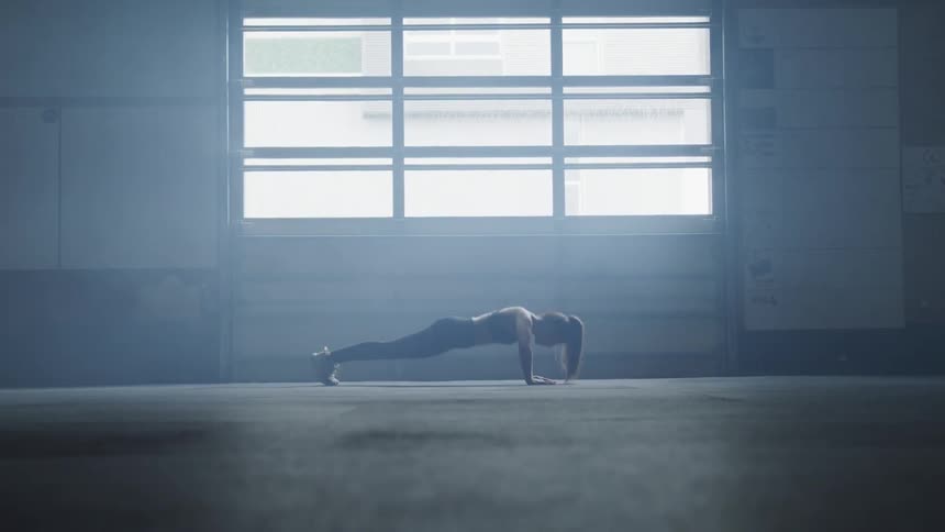 A woman does push ups near the window