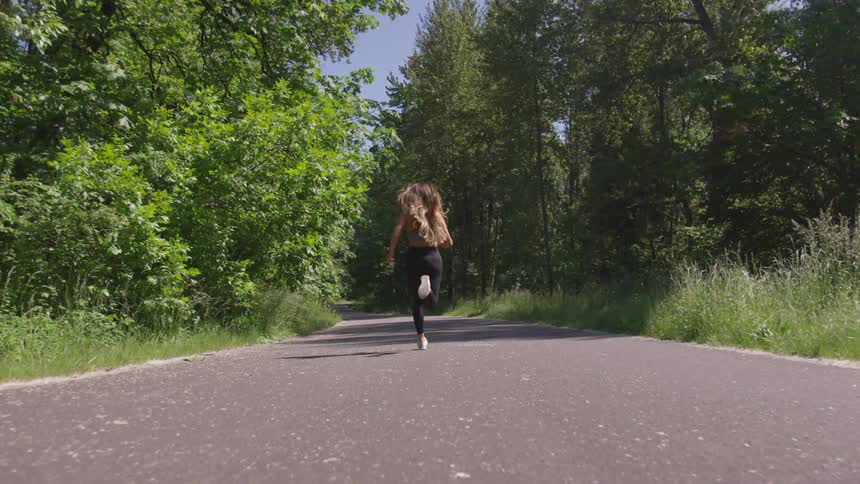 Woman running in the middle of the road