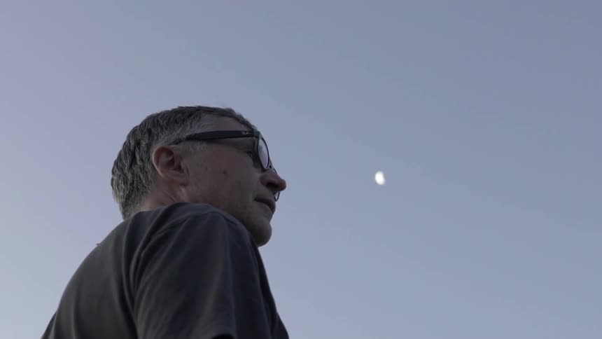 Man staring straight ahead turns head slightly