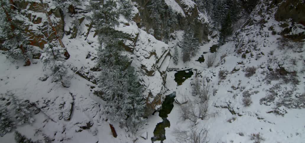 Birds eye view of snow in the river and on hills