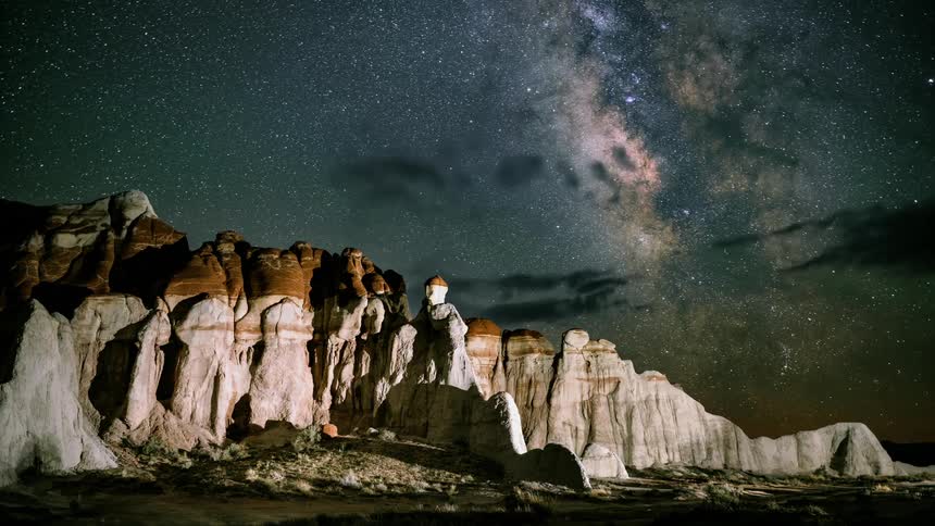A time lapse of a starry sky at astronomical sunrise over a mountain scene