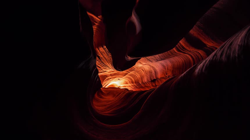 Sunlight glows orange in a slot canyon
