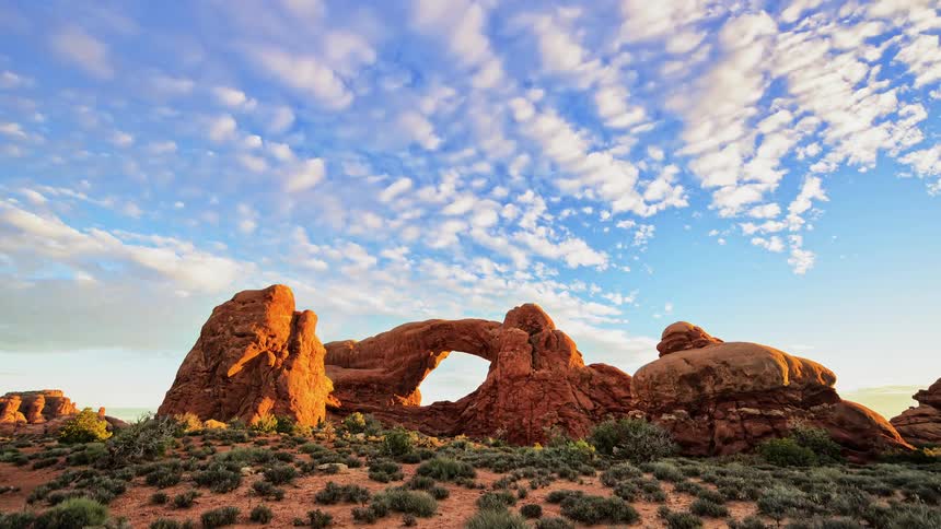 Clouds moving above an arch in the desert