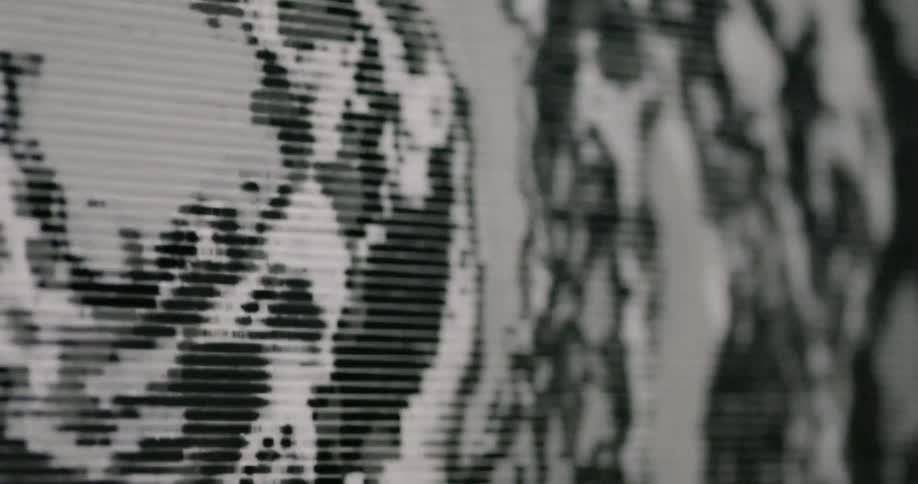 A pixelated image spinning on a monitor