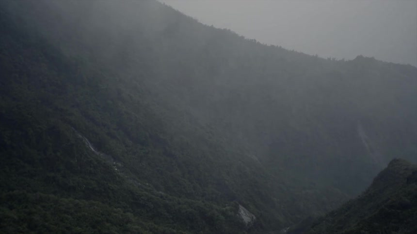 Rain and fog over tree covered hills and ridges