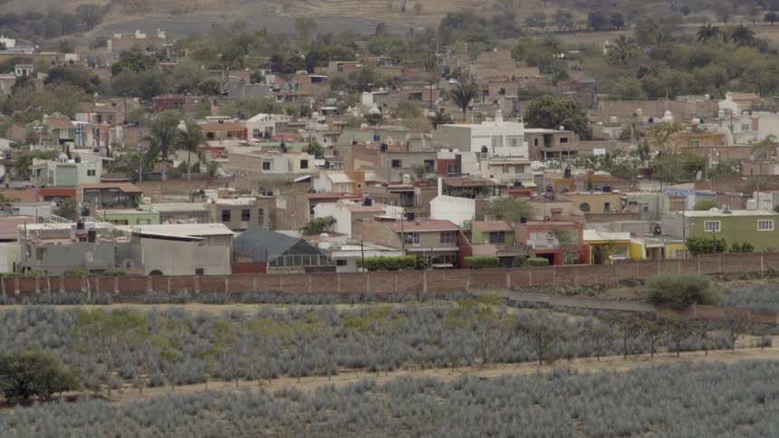 The town is on the hill with a fence in front
