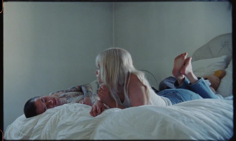 Young couple laying on bed in a bedroom