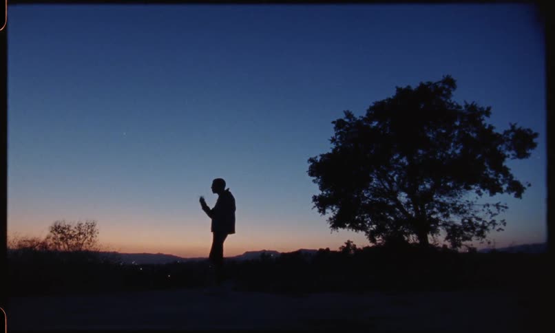 Man stands outside at night smoking