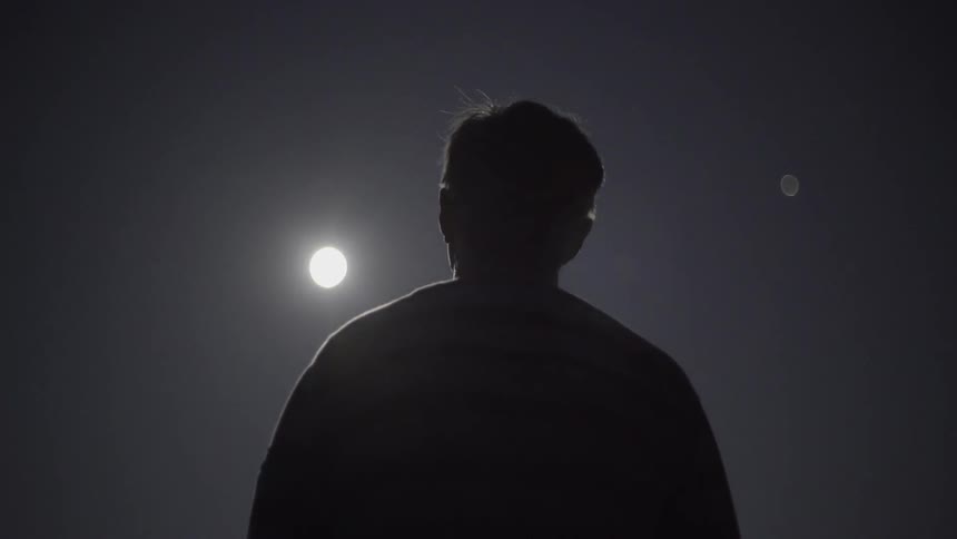 Someone Standing and Staring at the Moon in Quiet Night Sky Outdoors.