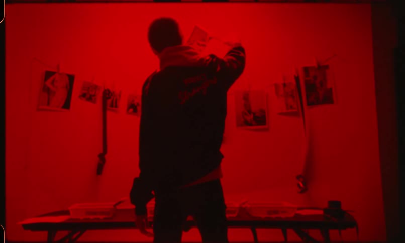 Man processing photographs on darkroom