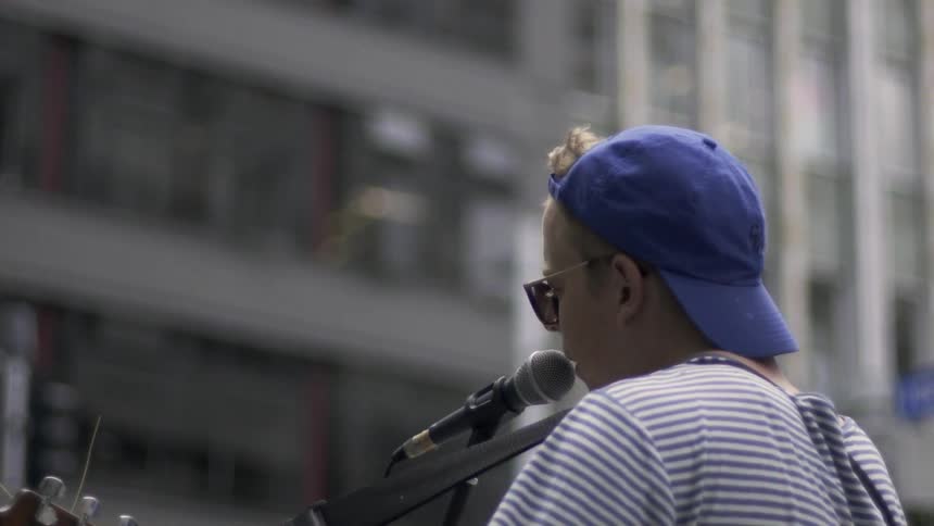 Person Singing in the City Street Capturing Urban Music Performance and Human Expression.