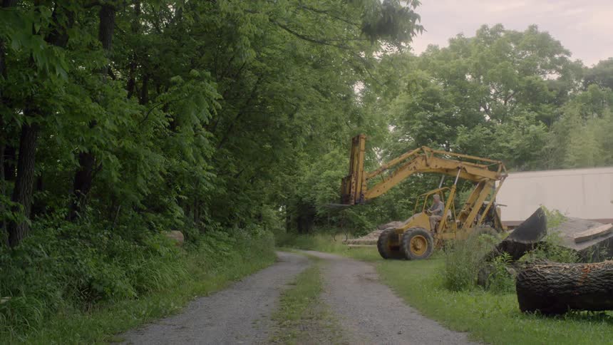 A construction vehicle moving towards a path