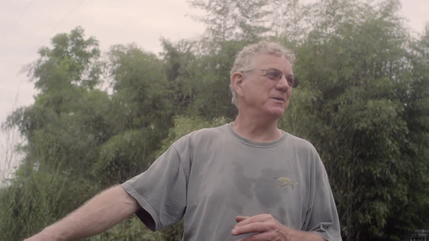 An old man explain something about a trunk