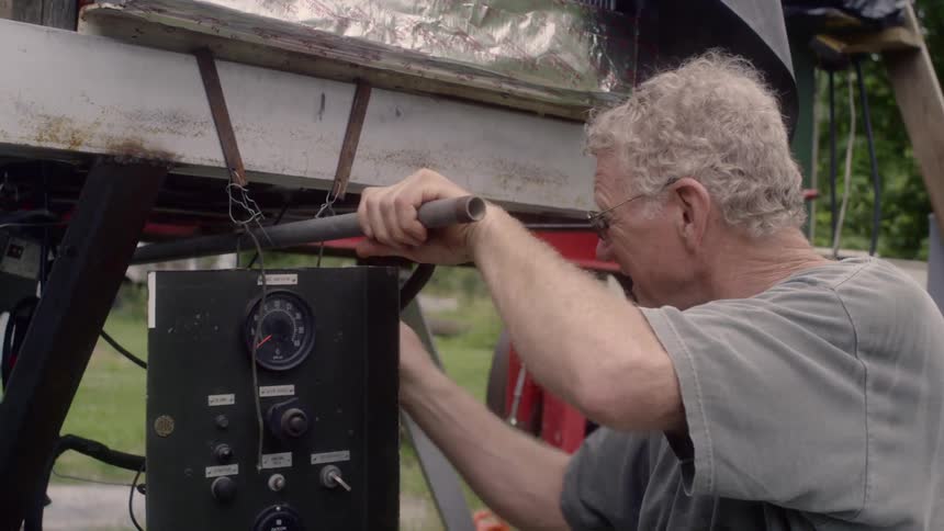 A man works with a sawmill