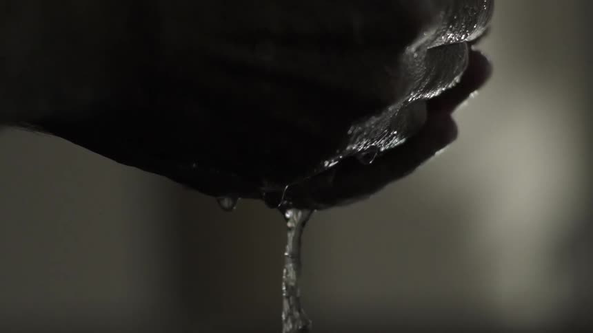 Water Running Smoothly Through Fingers Creating Gentle Ripples and Natural Flow.