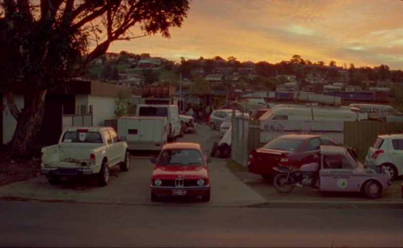 A car drives out of a busy lot
