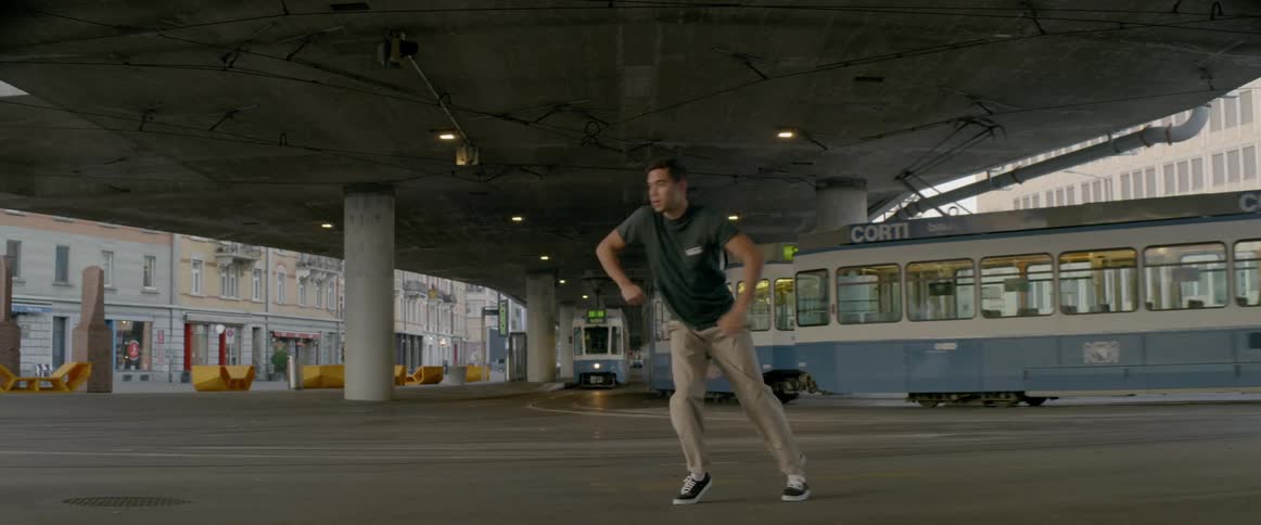 A young man dances in the street