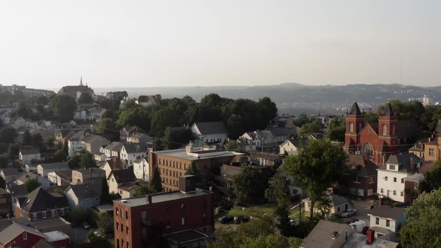 The town is on a hill on a cloudy day
