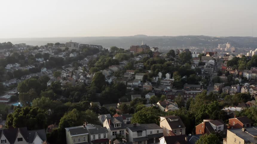 An aerial view of houses and trees in a city