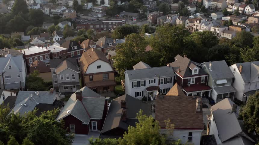 A crowded residential neighborhood is lined with numerous multistory homes