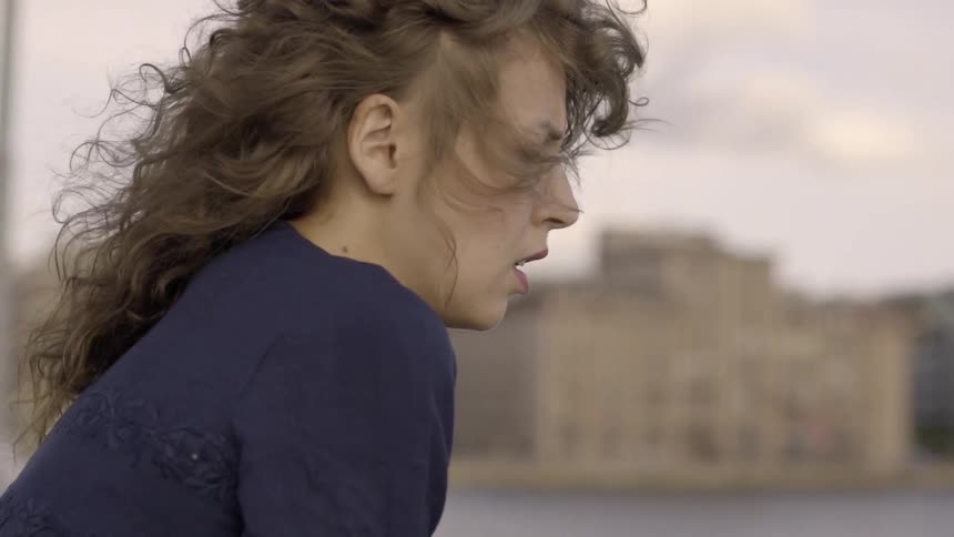 A woman is emotionally distraught on a bridge