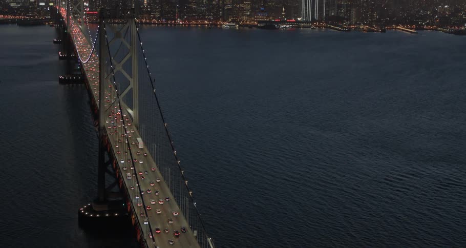 Cars are driving over a bridge above the ocean