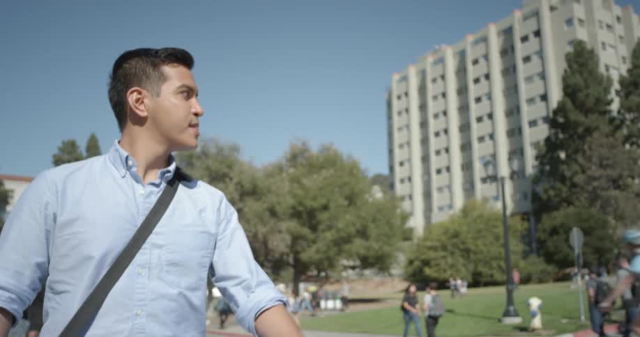 Man walking through a public park on sunny day