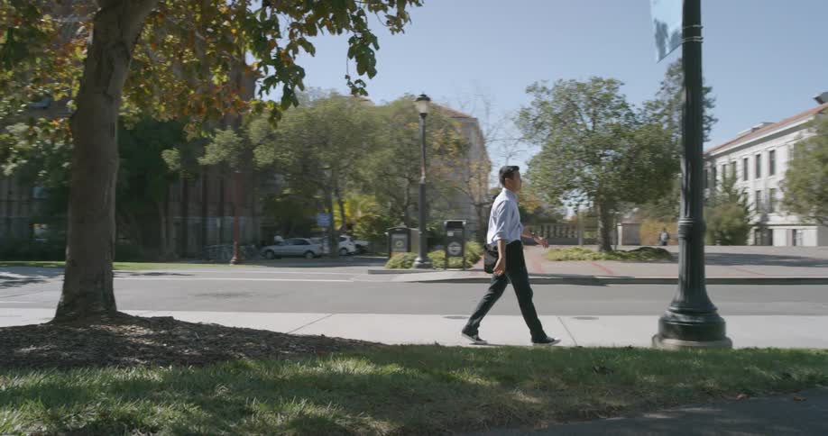 A man walks down the sidewalk