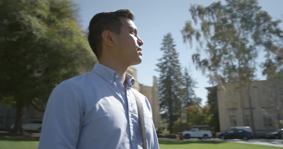 A man is standing outside of a building