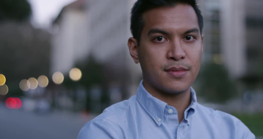 A young man stands and looks in to the distance