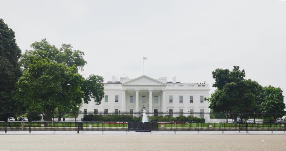 People are walking in front of the white house