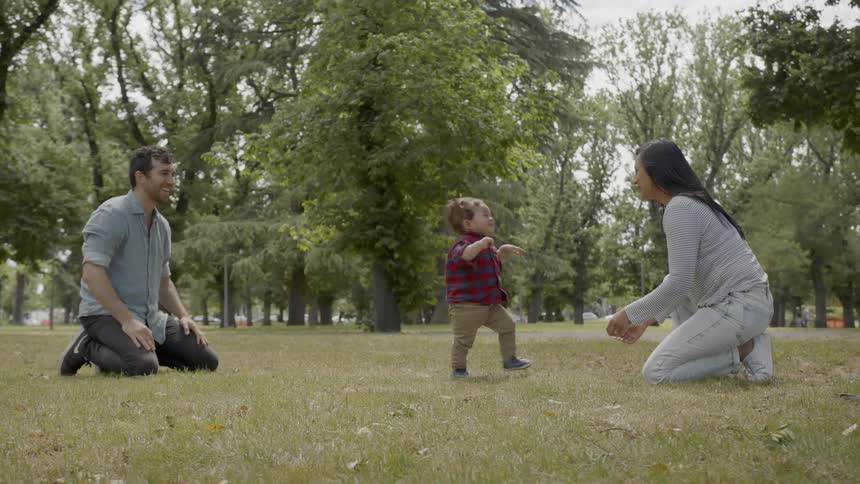 A young boy learning to walk