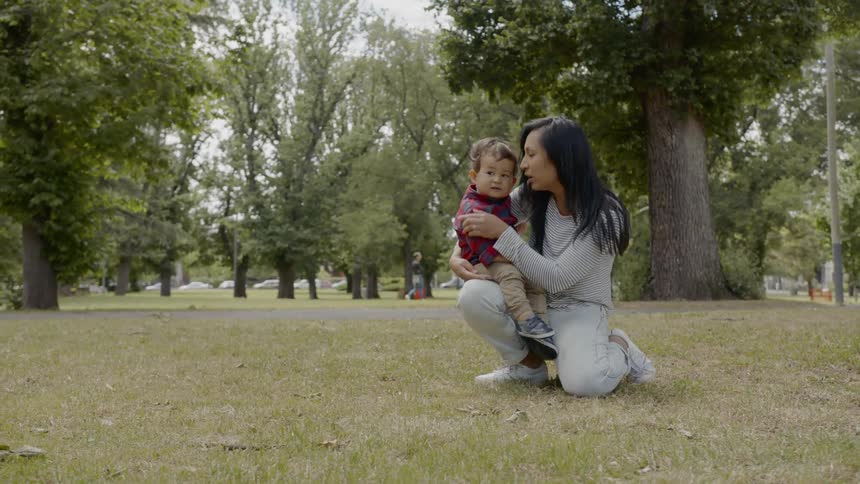 A mother and son spend time together in a park