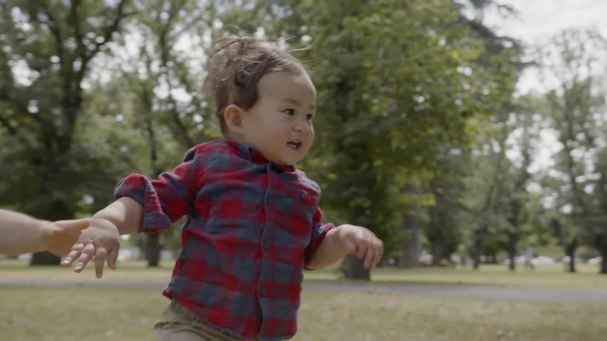 A father son and mom are playing outdoors