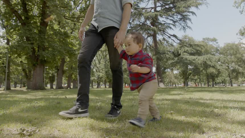 Father and son are walking outside