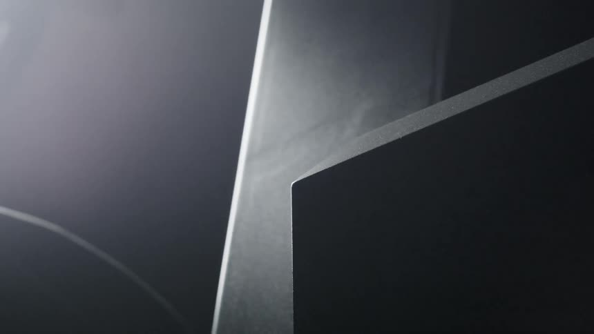 Metal arm moves light and device in arch