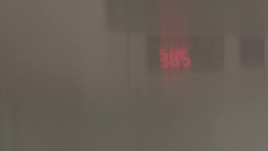 Digital numbers blurred behind smoke
