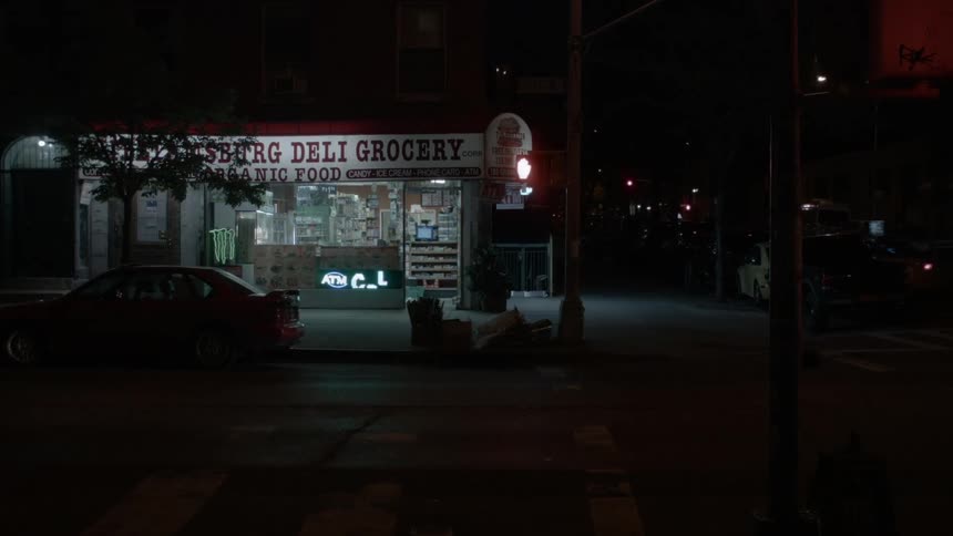 A convenience store on the corner of an intersection at night