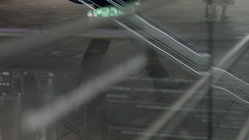 People go up and down on an escalator