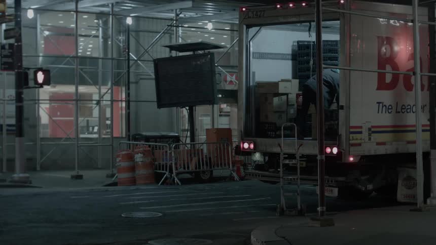 A man unloads boxes from the back of a truck