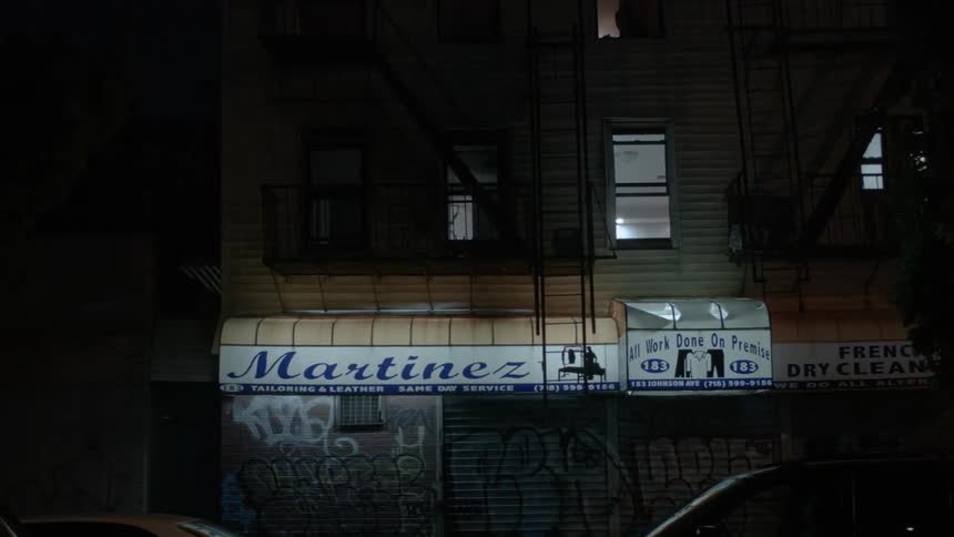 A dry cleaning store covered in graffiti