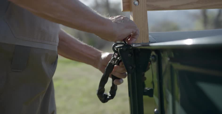 Man locks chain on truck bed tailgate