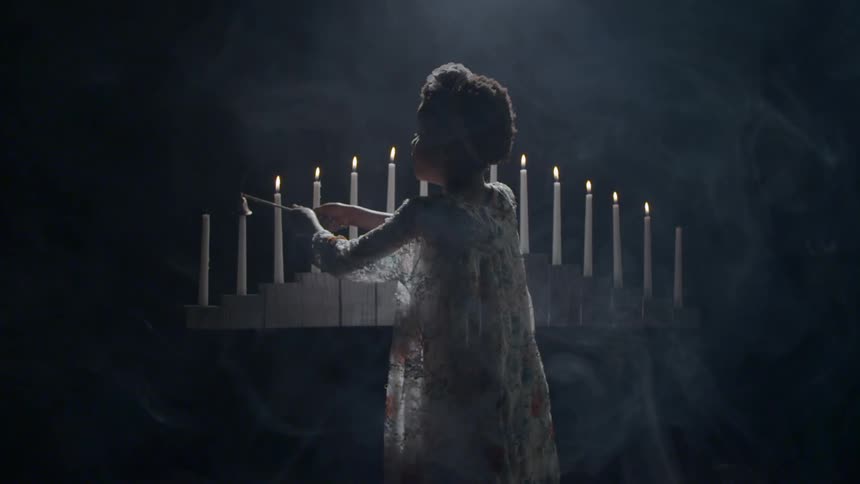A child is lighting candles