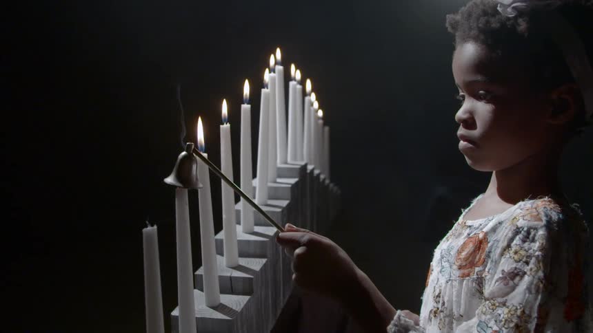 Girl putting out candles