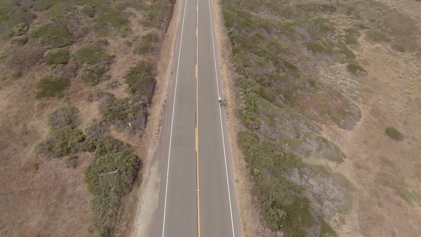 A car is driving down the road