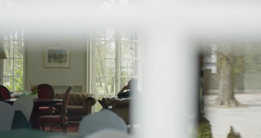 A person sits in a chair in a house