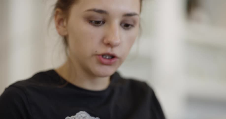 Girl talking while looking down