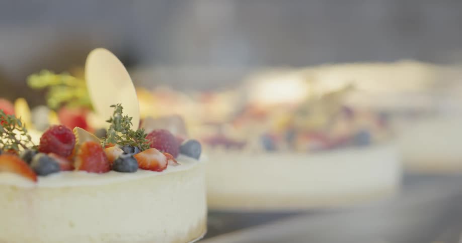 Cheesecakes with fruit on top sit on display